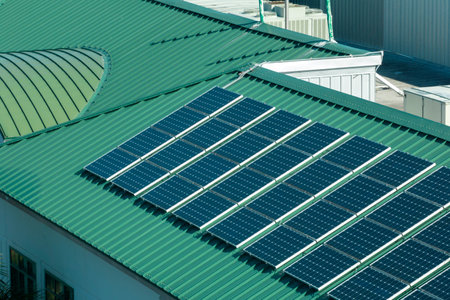View from above of american condo roof with blue solar photovoltaic panels for producing clean...