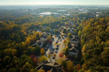 View from above of apartment residential condos between yellow fall trees in suburban area in South...