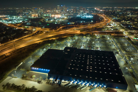 View from above of many parked cars on illuminaded parking lot with lines and markings for parking...