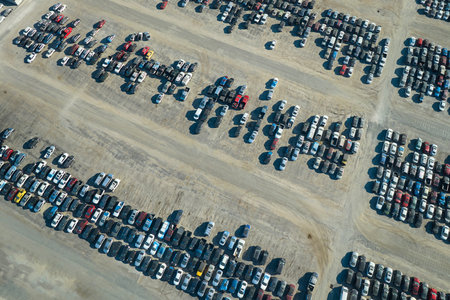 Aerial view of auction reseller company big parking lot with parked cars ready for remarketing...