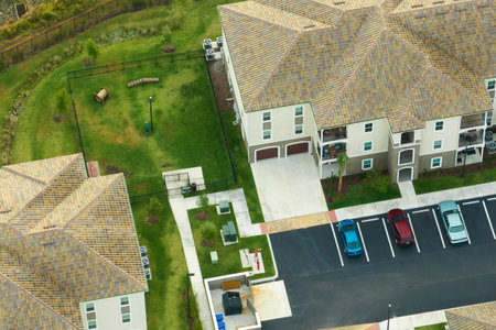 Aerial view of cars parked on parking places at american apartment building in Florida residential area. New family condos as example of housing development in US suburbsの写真素材