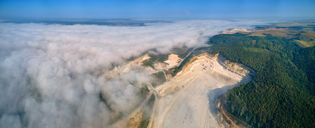 Aerial view of open pit mining site of limestone materials extraction for construction industry with...