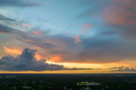 Colorful evening landscape with soft pastel coloured clouds on watercolor tinted sunset sky. Abstract nature backgroundの写真素材
