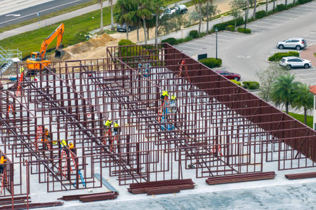 Construction site with many workers and equipment in Fort Myers, Florida. Hard labor employment at...