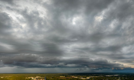 Heavy rain falling down from stormy clouds during thunderstorm on dark sky. Moving and changing...