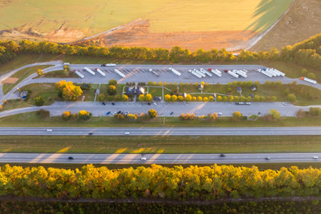 Parking rest area for cargo tractor-trailers near American interstate freeway. Resting place during...