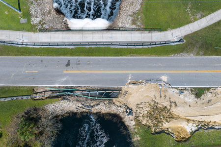Road construction. Repair of destroyed bridge after hurricane flooding water washed away asphalt in...