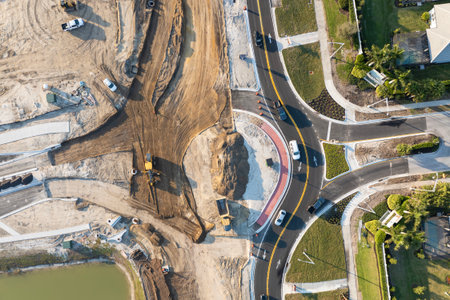 Roadworks construction site at roundabout intersection on American highway. Development of city...