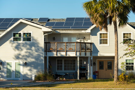 Aerial view of regular american home roof with blue solar photovoltaic panels for producing clean ecological electric energy. Investing in renewable electricity for retirement incomeの写真素材