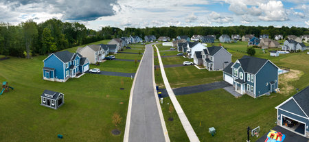 Aerial view of private residential houses in rural suburban sprawl area in Rochester, New York. Upscale suburban homes with large backyards and green grassy lawns in summer seasonの写真素材