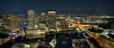 Night urban landscape of downtown district of Tampa city in Florida, USA. Skyline with moving traffic and brightly illuminated high skyscraper buildings in modern american megapolisの写真素材