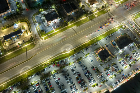 Strip mall plaza in North Port, Florida with illuminated traffic driving cars. USA transportation infrastructure conceptの写真素材