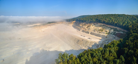 Aerial view of open pit mining of limestone materials for construction industry with excavators and dump trucksの写真素材