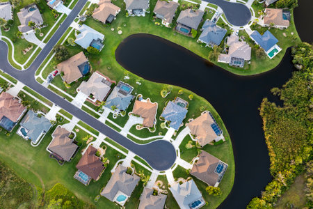 Cul de sac street dead end and private residential houses in rural suburban sprawl area in North Port, Florida. Upscale suburban homes with large waterfront backyardsの写真素材