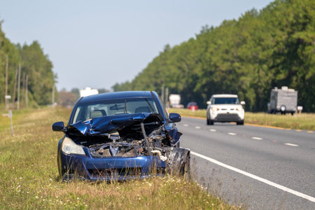Dumped crashed car after traffic accident parked on highway roadsideの写真素材