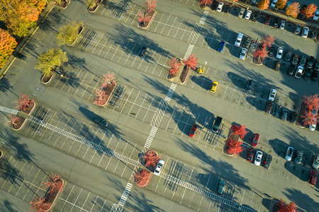 View from above of many parked cars on parking lot with lines and markings for parking places and directions. Place for vehicles in front of a strip mall centerの写真素材