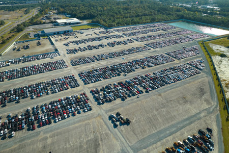 Aerial view of auction reseller company big parking lot with parked cars ready for remarketing services. Sales of secondhand vehiclesの写真素材