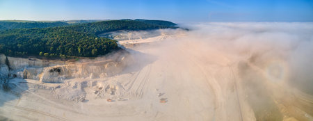 Aerial view of open pit mining of limestone materials for construction industry with excavators and dump trucksの写真素材