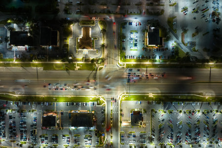 Aerial view of shopping plaza stores and American wide highway with many driving cars in North Port,...