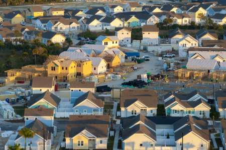 Aerial view of unfinished wooden frames of affordable houses under construction. Development of residential housing in American suburbs. Real estate market in the USAの写真素材