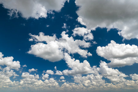 Bright landscape of blue sky with flying white clouds. Colorful summer skyscape