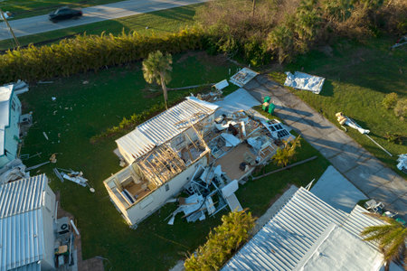 Hurricane strong wind destroyed suburban house roofs in Florida mobile home residential area....