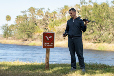 Man is sad that he is not allowed to fly his quadcopter in a state park no drone area. Operator is...