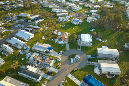 Severely damaged houses after hurricane Ian in Florida mobile home residential area. Consequences of natural disasterの写真素材