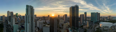 View from above of concrete and glass skyscraper buildings in downtown district of Miami Brickell in Florida, USA at sunset. American megapolis with business financial district at nightfallの写真素材