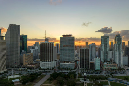 Aerial view of downtown district of of Miami Brickell in Florida, USA at sunset. High skyscraper buildings and street with cars and Metrorail traffic in modern american midtownの写真素材