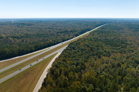 Elevated view of freeway exit junction over road lanes with fast moving traffic cars and trucks....