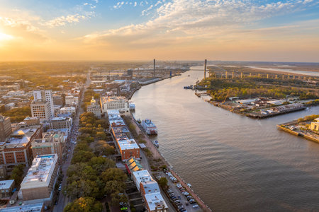 Historical American city architecture at night. River Street in Savannah, old city in Georgia state. Illuminated streets and buildings from aboveの写真素材