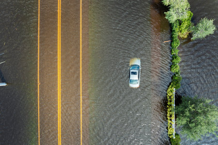 Hurricane Debby flooded city street with trapped car submerged under water in Florida residential...