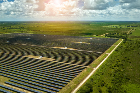 Aerial view of big sustainable electric power plant with many rows of solar photovoltaic panels for producing clean electrical energy. Renewable electricity with zero emission conceptの写真素材