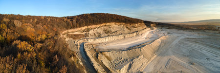 Aerial view of open pit mining site of limestone materials for construction industry with excavators and dump trucksの写真素材