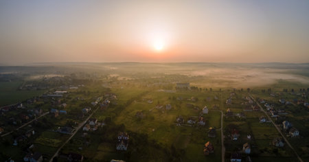 Aerial view of residential houses in suburban rural area at sunsetの写真素材