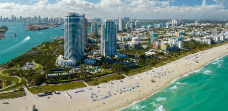 Aerial view of South Beach sandy surface with tourists relaxing on hot Florida sun. Miami Beach city with high luxury hotels and condos. Tourism infrastructure in southern USAの写真素材
