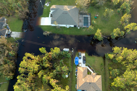 Aftermath of natural disaster. Surrounded by hurricane rainfall flood waters homes in Florida residential areaの写真素材