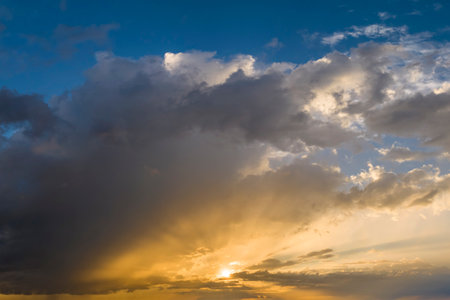 Amazing skyscape. Evening sky with bright colorful orange and yellow cloudsの写真素材