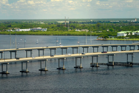 Barron Collier Bridge and Gilchrist Bridge in Florida with moving traffic. Transportation infrastructure in Charlotte County connecting Punta Gorda and Port Charlotte over Peace Riverの写真素材
