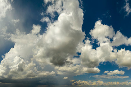 Bright landscape of blue sky with flying white clouds. Colorful summer skyscapeの写真素材