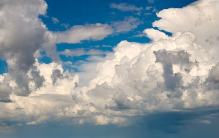 Bright landscape of blue sky with flying white clouds. Colorful summer skyscapeの写真素材
