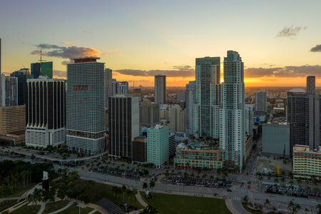 Evening urban landscape of downtown district of Miami Brickell in Florida USA. Skyline with dark high skyscraper buildings and street with cars and Metrorail traffic in modern american megapolisの写真素材