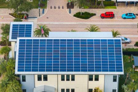 Florida office building with solar roof. Blue photovoltaic panels for producing clean ecological electric energy. Investing in renewable electricity conceptの写真素材