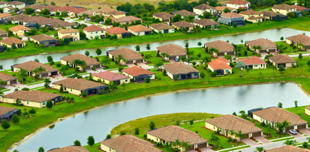 View from above of densely built residential houses in closed living clubs in south Florida. American dream homes as example of real estate development in US suburbsの写真素材