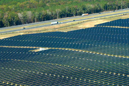 Aerial view of big sustainable electric power plant with many rows of solar photovoltaic panels for producing clean electrical energy. Renewable electricity with zero emission conceptの写真素材