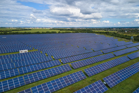 Aerial view of large sustainable electrical power plant with rows of solar photovoltaic panels for producing clean electric energy. Concept of renewable electricity with zero emissionの写真素材