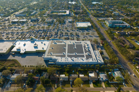 Aerial view of many cars parked on parking lot in front of a grocery mall storeの写真素材