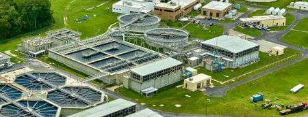 Aerial view of modern water cleaning facility at urban wastewater treatment plant. Purification process of removing undesirable chemicals, suspended solids and gases from contaminated liquid.の写真素材