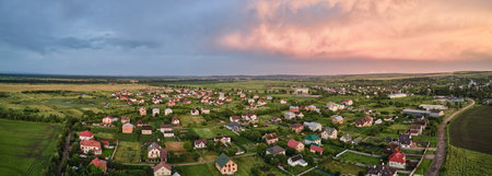 Aerial view of residential houses in suburban rural area at sunsetの写真素材